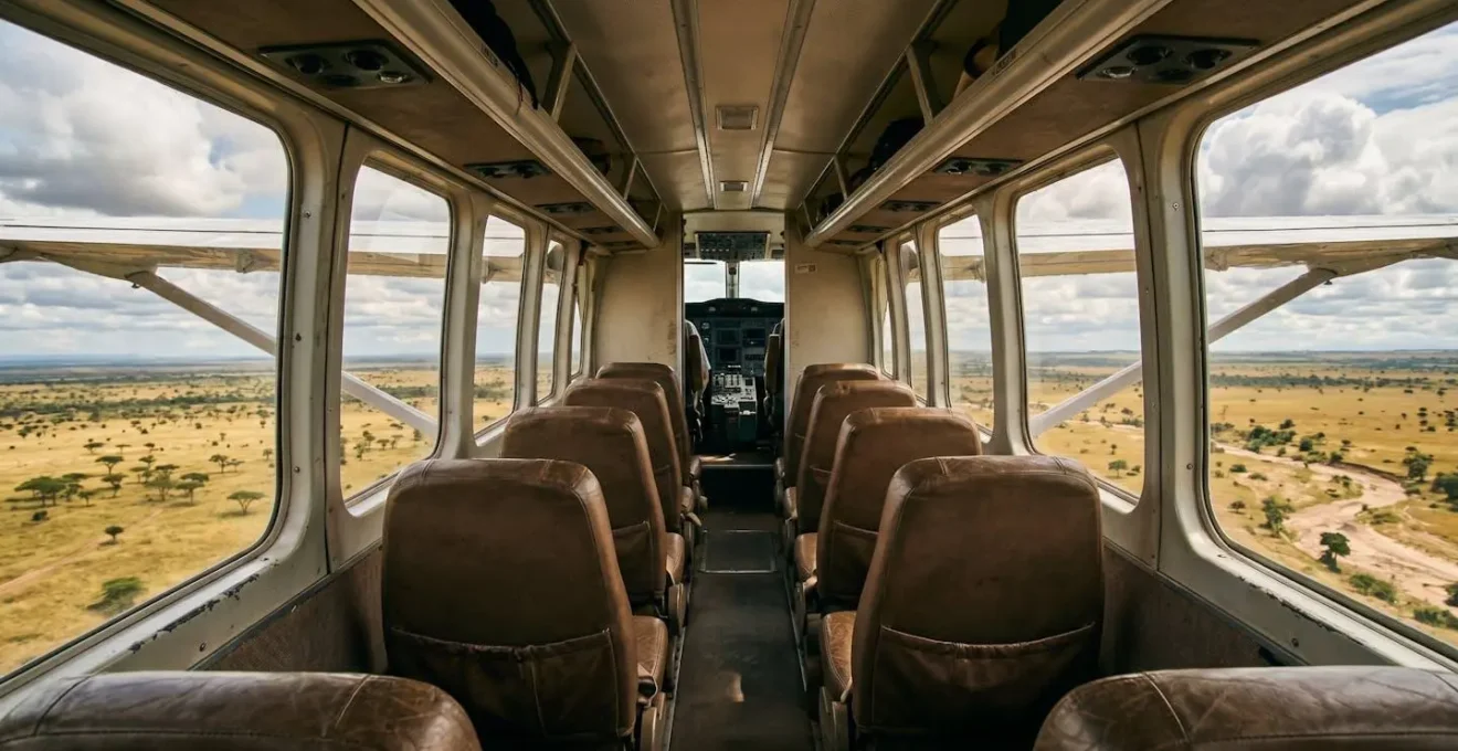 Wide-angle interior view from passenger seat showing spacious cabin and panoramic windows of bush plane