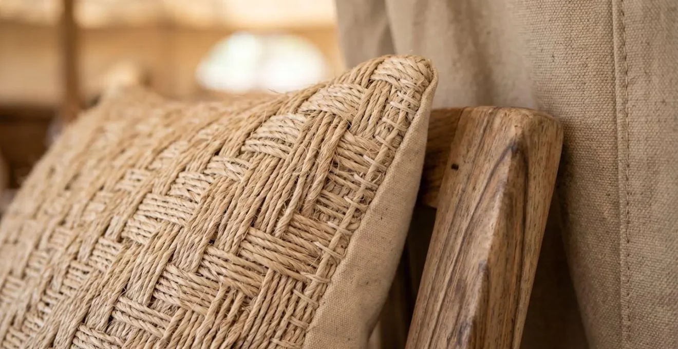 Close-up of handwoven local textiles and sustainable materials in a safari tent interior